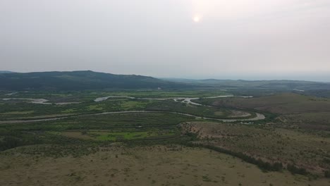 Aerial-drone-shot-of-a-river-Russian-and-Mongolian-border-during-sunset